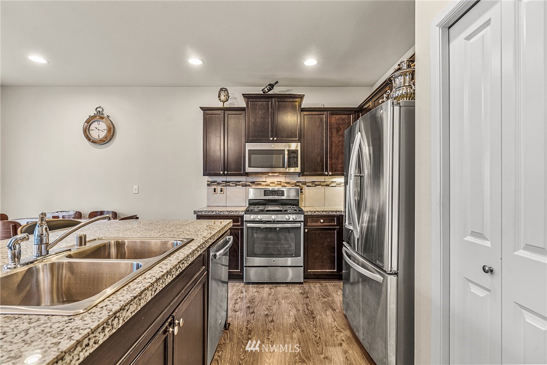 3627 202nd Pl S East Bothell, WA 98012 - Photo 10 of 38 a kitchen with granite countertop a refrigerator and a sink