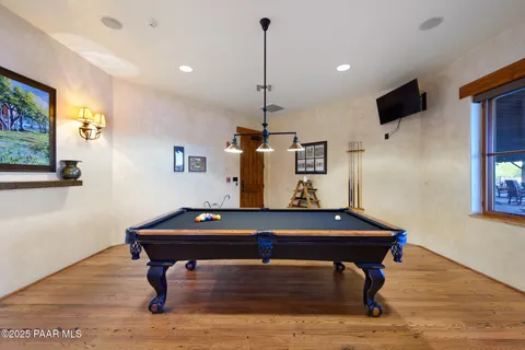 a room with table chairs and wooden floor
