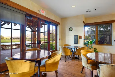 a dining room with furniture a chandelier and wooden floor