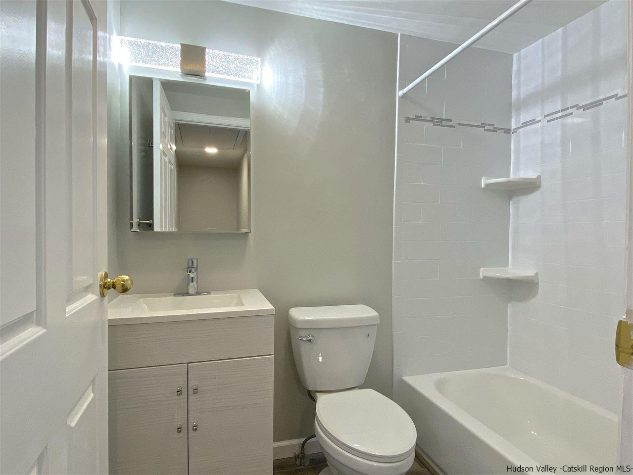 96 Rinaldi Boulevard Poughkeepsie, NY 12601 - Photo 15 of 23 a bathroom with a toilet sink vanity tub and shower