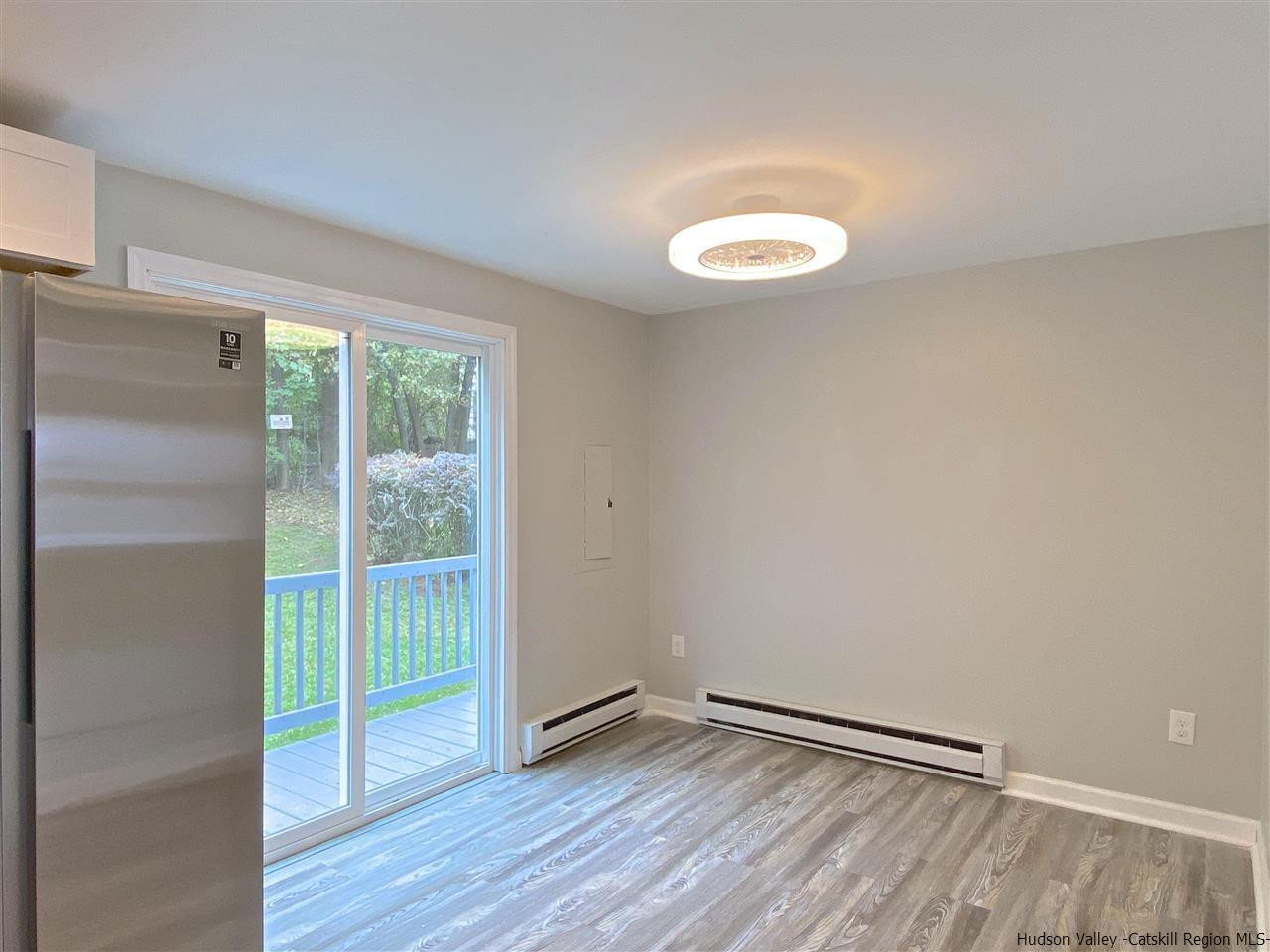96 Rinaldi Boulevard Poughkeepsie, NY 12601 - Photo 6 of 23 a view of a room with wooden floor and sliding window