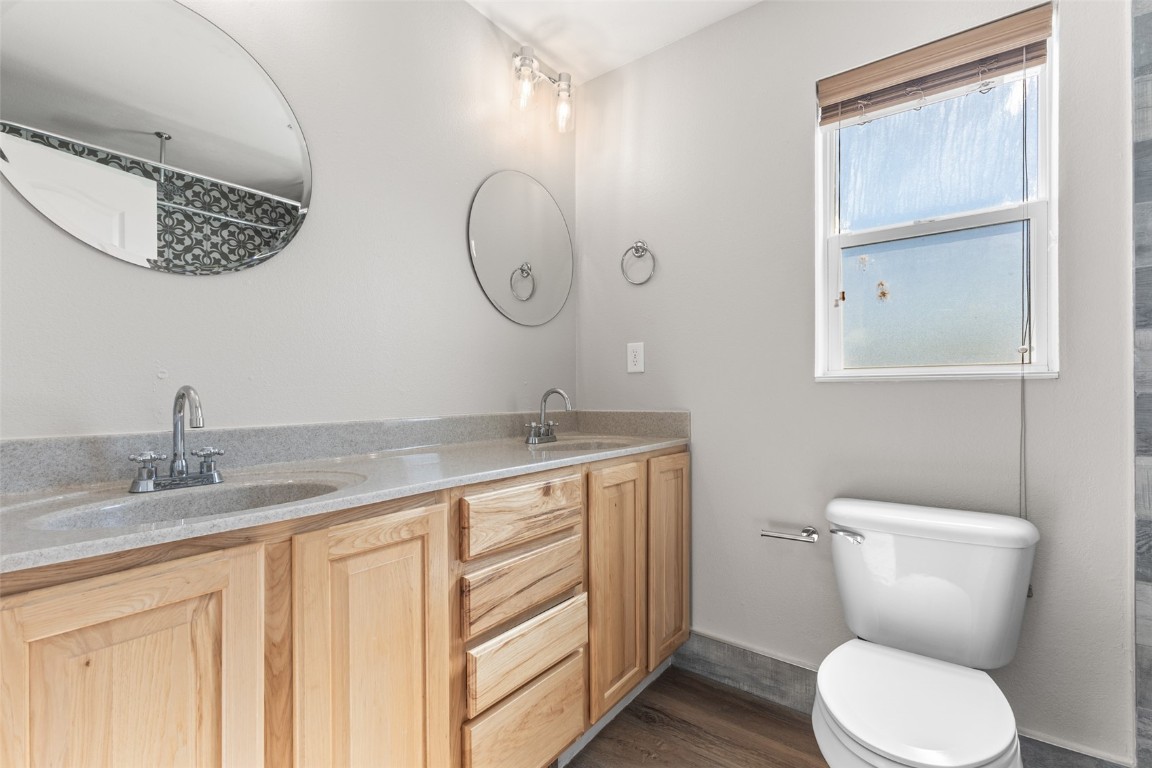 324 Little Bend Road Hayden, CO 81639 - Photo 19 of 35 a bathroom with a granite countertop toilet sink and mirror
