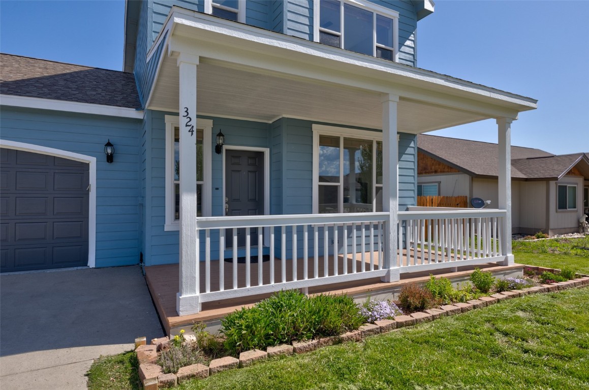 324 Little Bend Road Hayden, CO 81639 - Photo 32 of 35 a view of a house with a small yard and flower plants