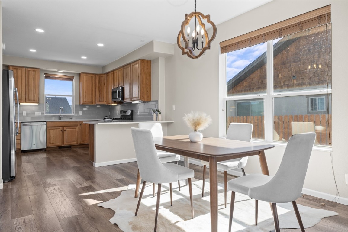 324 Little Bend Road Hayden, CO 81639 - Photo 7 of 35 a kitchen with a dining table chairs and white cabinets