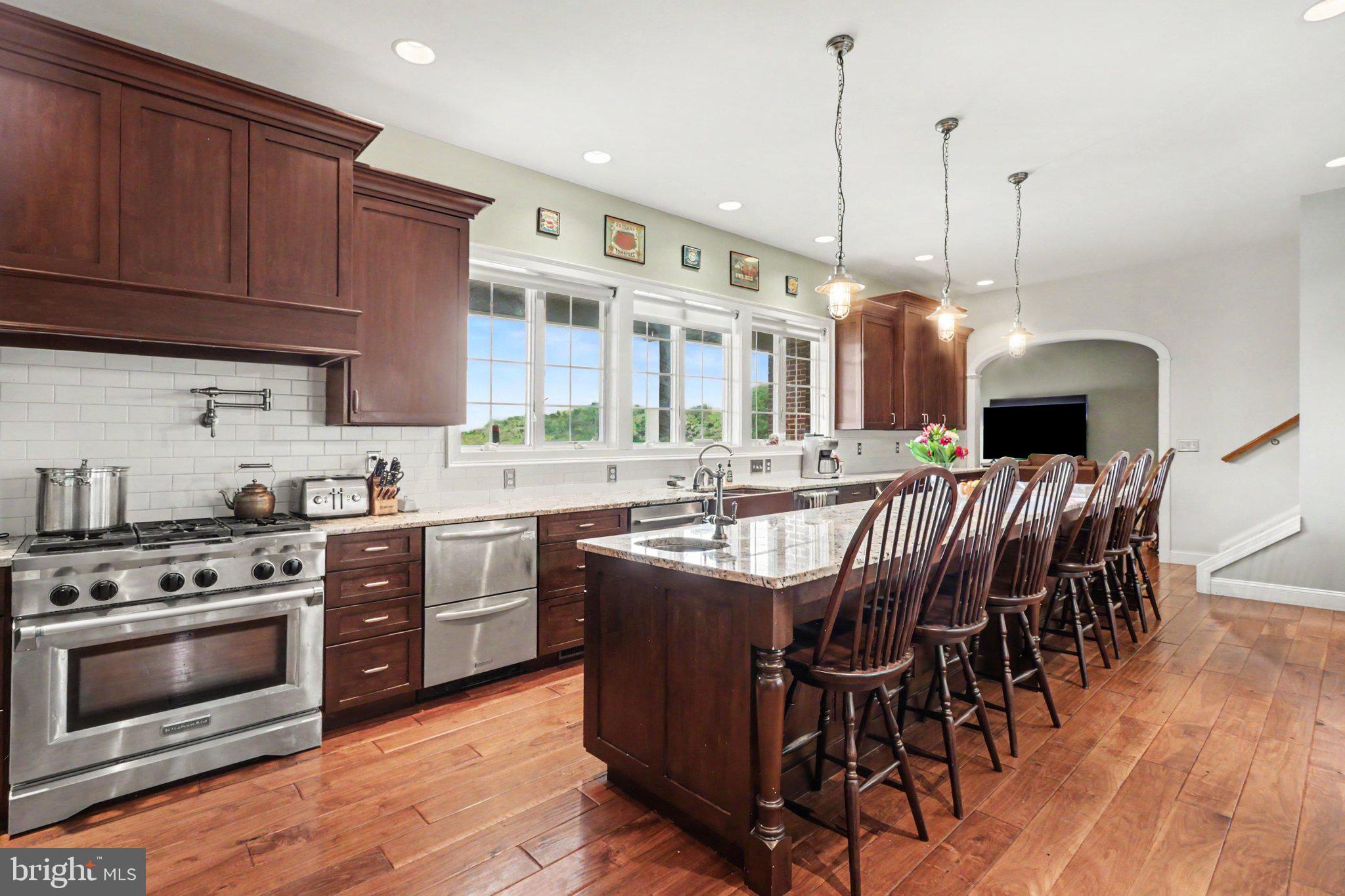 1080 Swatara Road Hershey, PA 17033 - Photo 5 of 59 a kitchen with stainless steel appliances granite countertop a stove top oven a sink dishwasher and a dining table with wooden floor