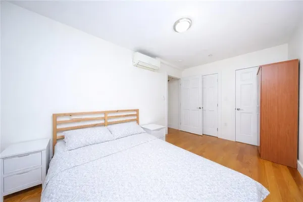 a bedroom with a bed and a night stand