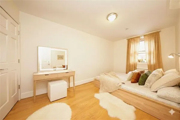 a bedroom with a bed and a desk