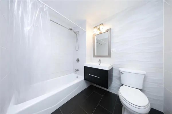 a bathroom with a toilet a sink and bathtub