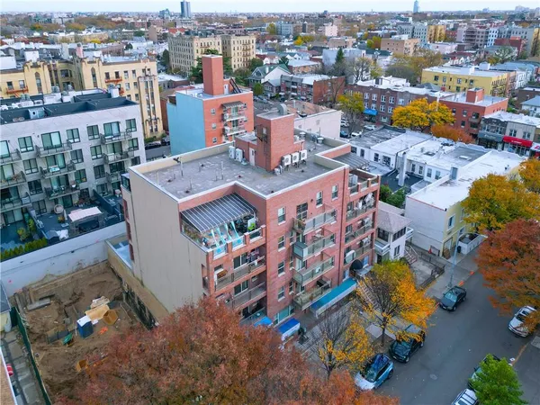 an aerial view of a houses with yard