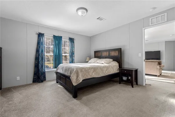 a bedroom with a bed and a lamp
