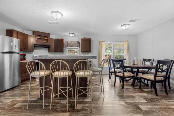 a view of a dining room with furniture and wooden floor