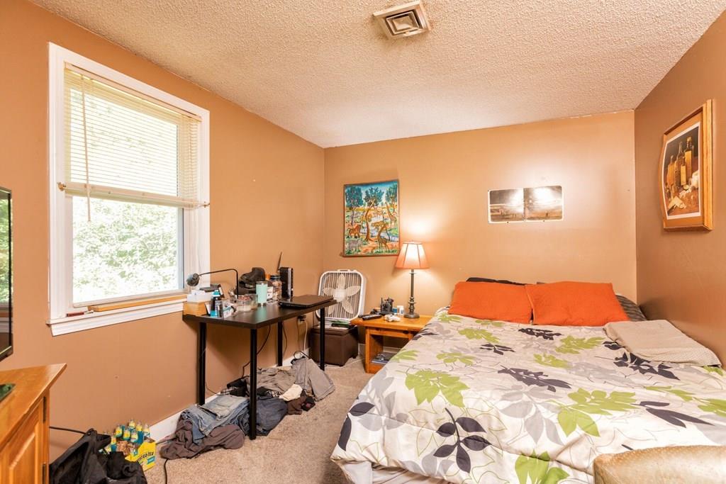 57 Christopher Road Rowley, MA 01969 - Photo 12 of 19 a bedroom with a bed and wooden floor