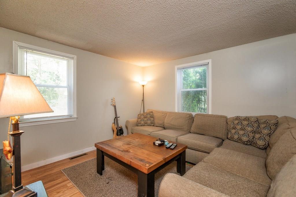 57 Christopher Road Rowley, MA 01969 - Photo 6 of 19 a living room with furniture and a window