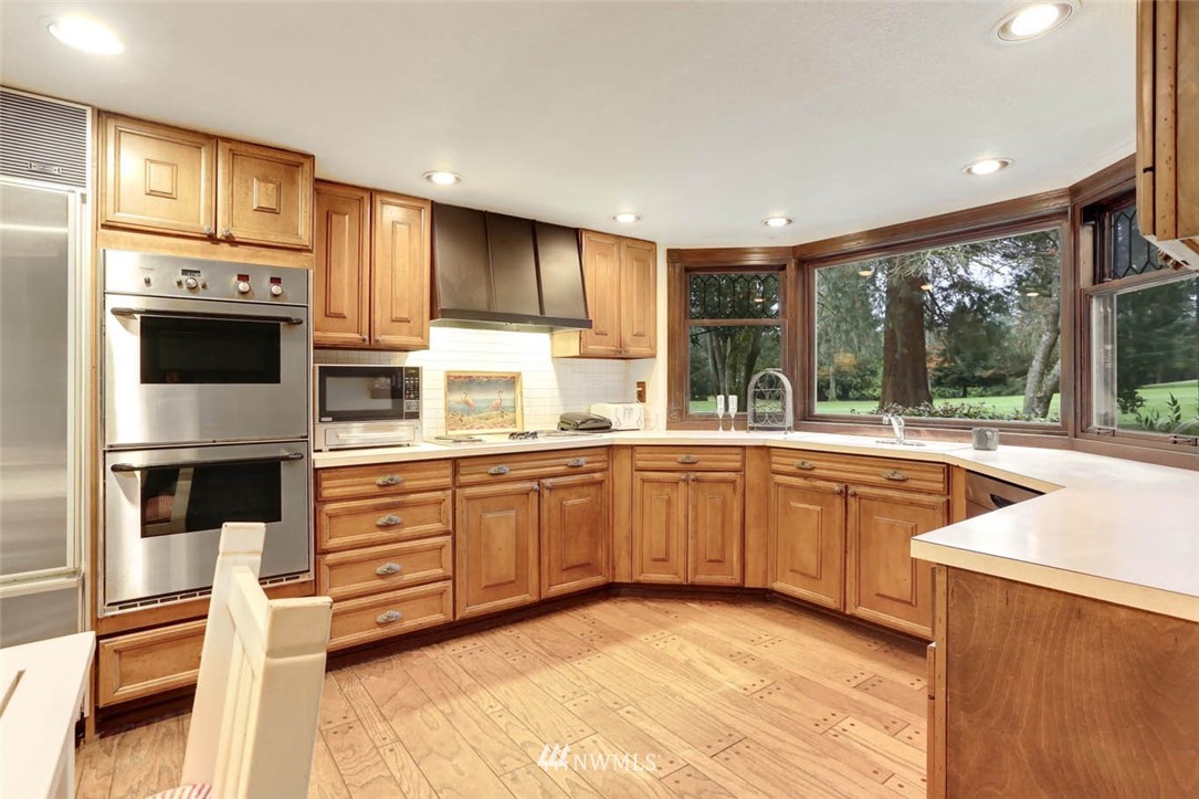 14811 Southeast 172nd Place Renton, WA 98058 - Photo 9 of 24 a kitchen with stainless steel appliances granite countertop a stove and a sink