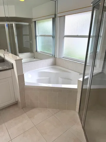 a bathroom with a sink vanity and mirror
