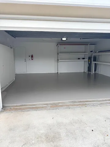 a front view of a house with a garden and trees