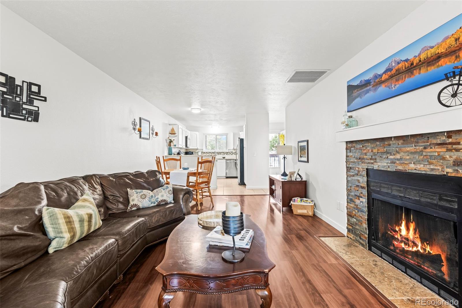 8450 Decatur Street, Unit 98 Westminster, CO 80031 - Photo 2 of 23 a living room with furniture and a fireplace