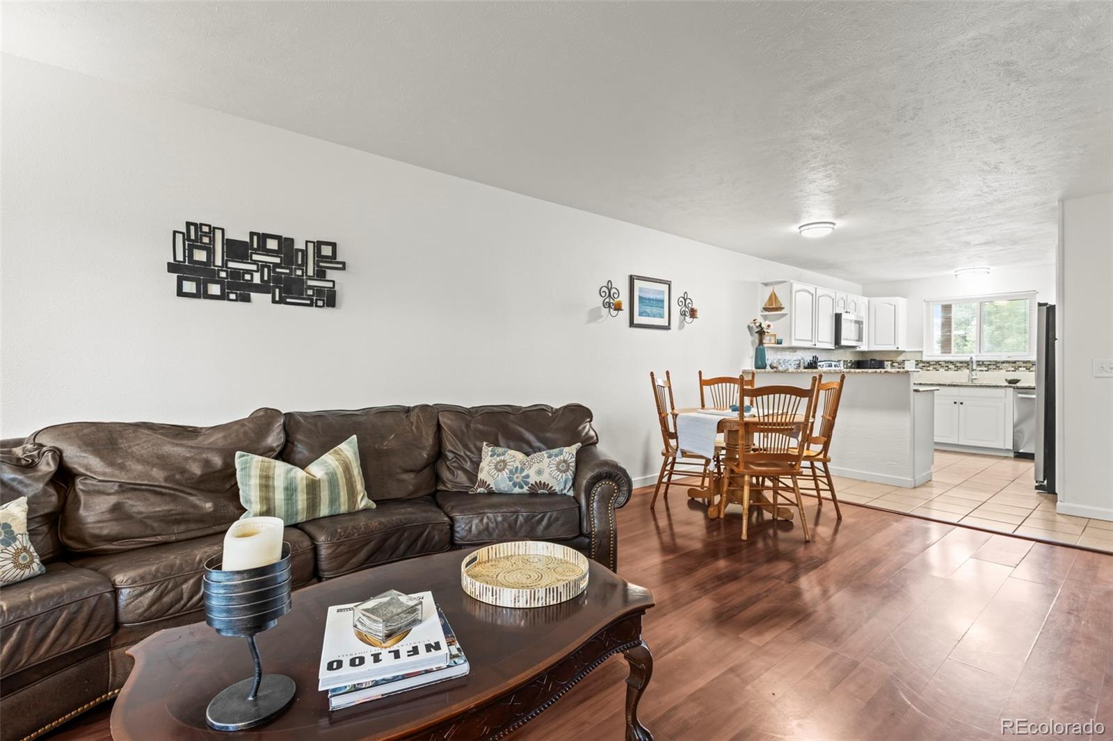 8450 Decatur Street, Unit 98 Westminster, CO 80031 - Photo 4 of 23 a living room with furniture and a table