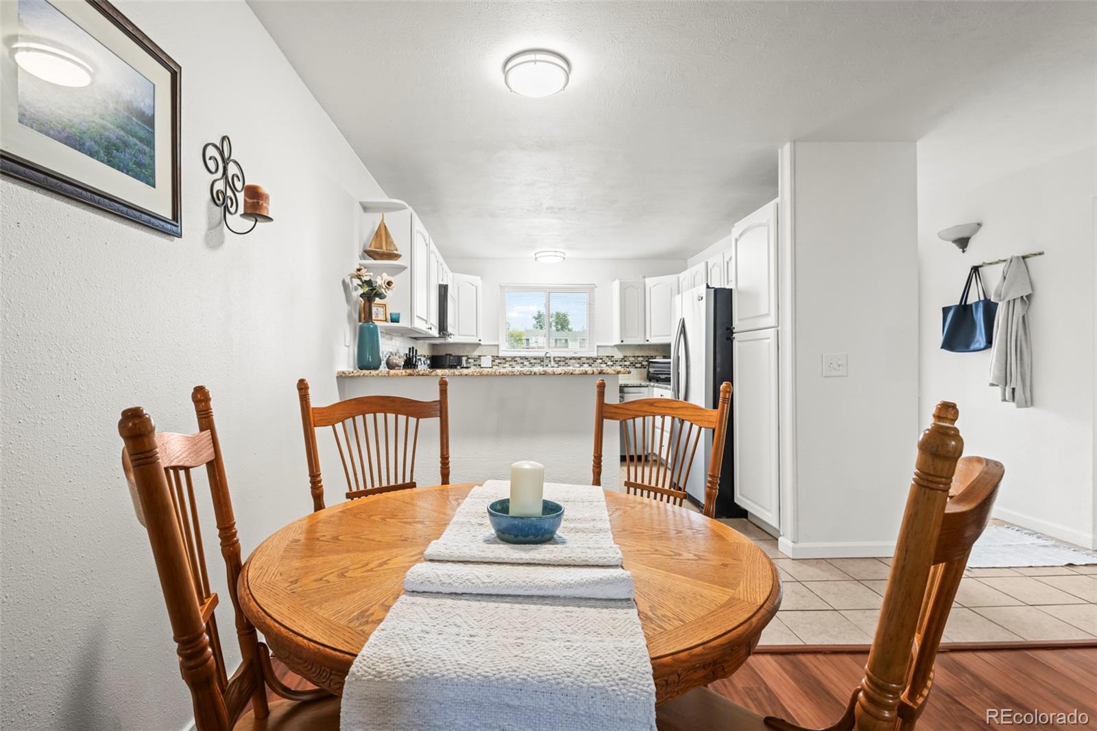 8450 Decatur Street, Unit 98 Westminster, CO 80031 - Photo 8 of 23 a dining room with furniture and wooden floor