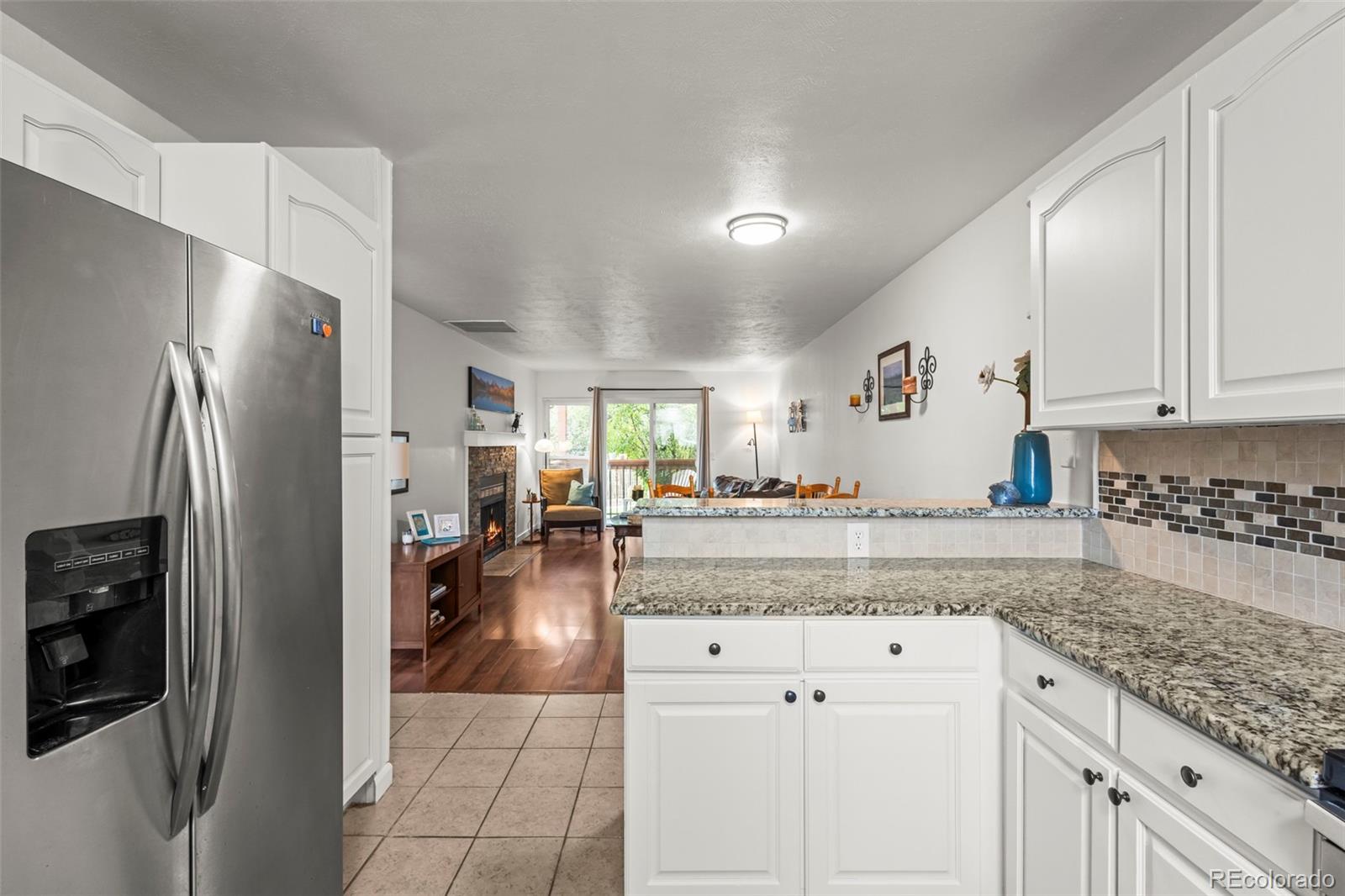 8450 Decatur Street, Unit 98 Westminster, CO 80031 - Photo 10 of 23 a kitchen with stainless steel appliances granite countertop a refrigerator and a stove