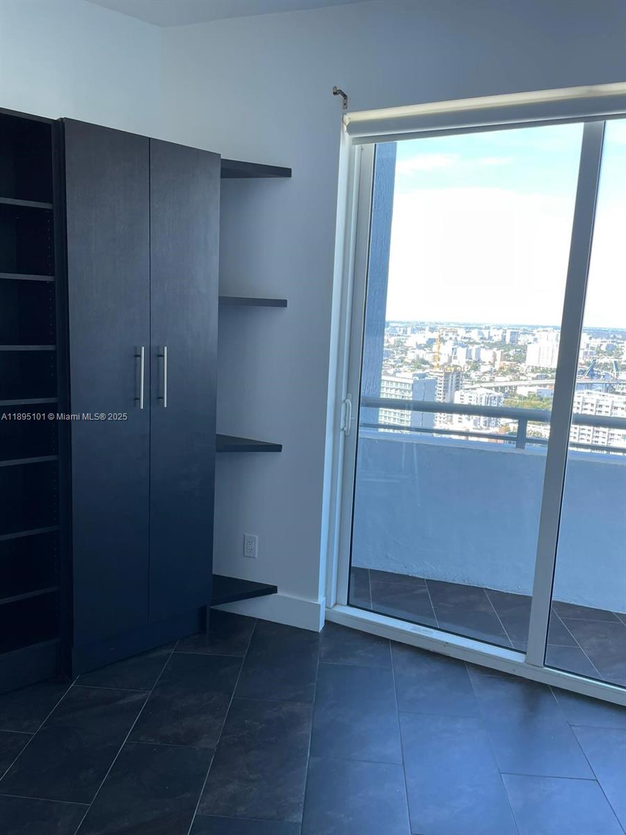 60 Southwest 13th Street, Unit 3426 Miami, FL 33130 - Photo 16 of 32 a view of empty room with wooden floor and fan