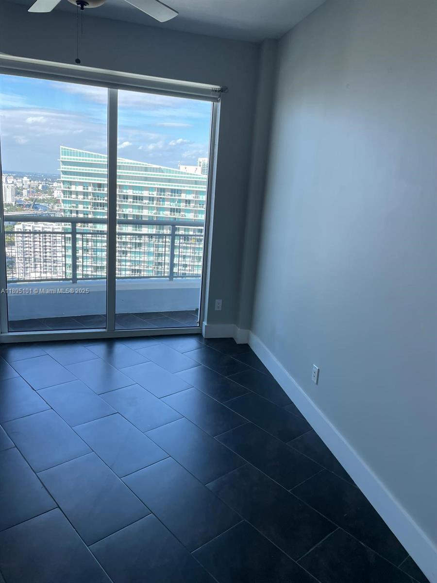 60 Southwest 13th Street, Unit 3426 Miami, FL 33130 - Photo 25 of 32 a view of empty room with wooden floor and fan