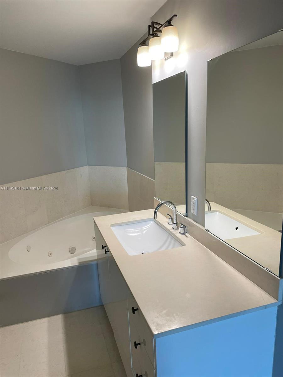 60 Southwest 13th Street, Unit 3426 Miami, FL 33130 - Photo 32 of 32 a bathroom with a sink and a mirror