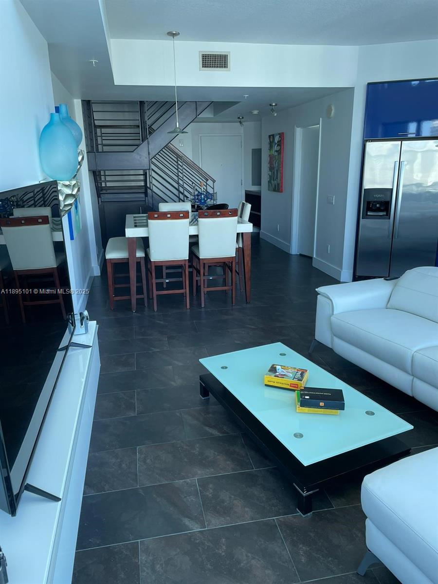 60 Southwest 13th Street, Unit 3426 Miami, FL 33130 - Photo 10 of 32 a living room with furniture and a table