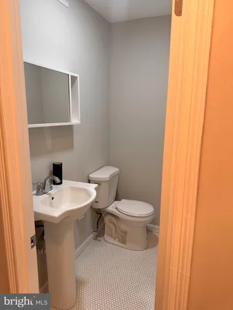 a white toilet sitting next to a bathroom sink