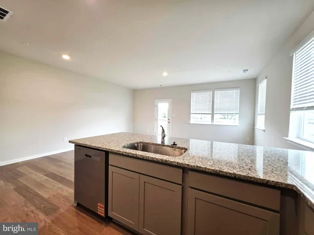 a bath room with granite countertop cabinets and sink