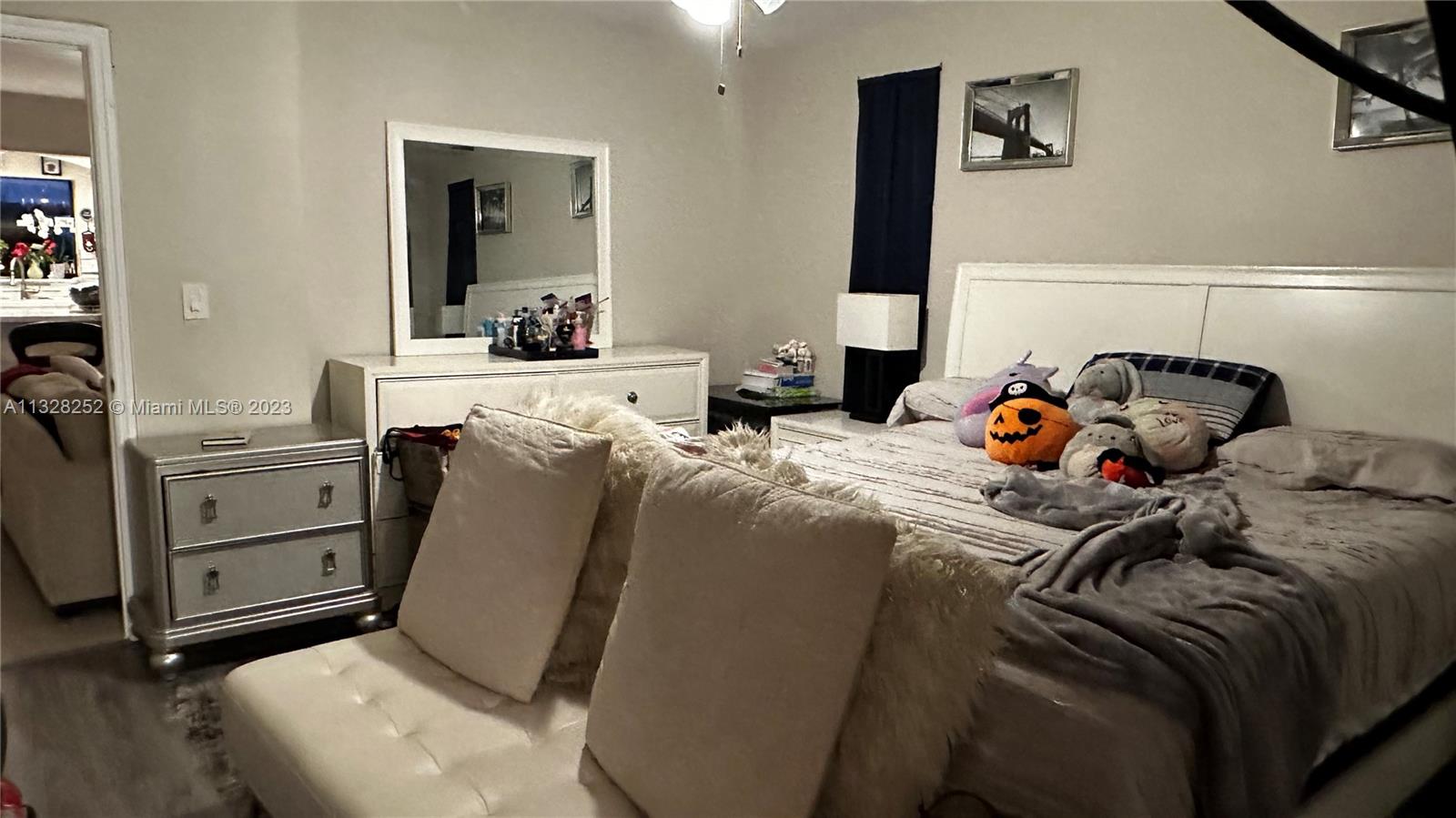 7810 Raleigh Street Hollywood, FL 33024 - Photo 11 of 16 a bedroom with a bed and large mirror