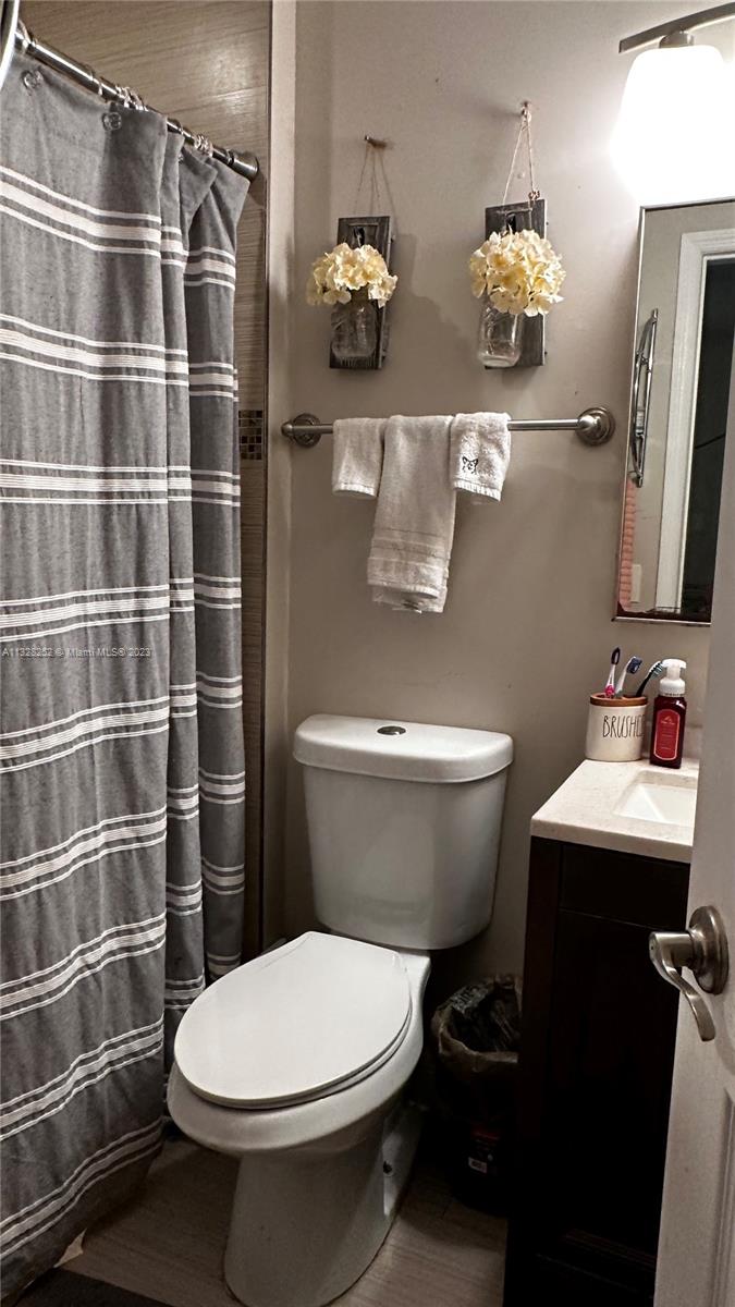 7810 Raleigh Street Hollywood, FL 33024 - Photo 12 of 16 a bathroom with a toilet and a shower