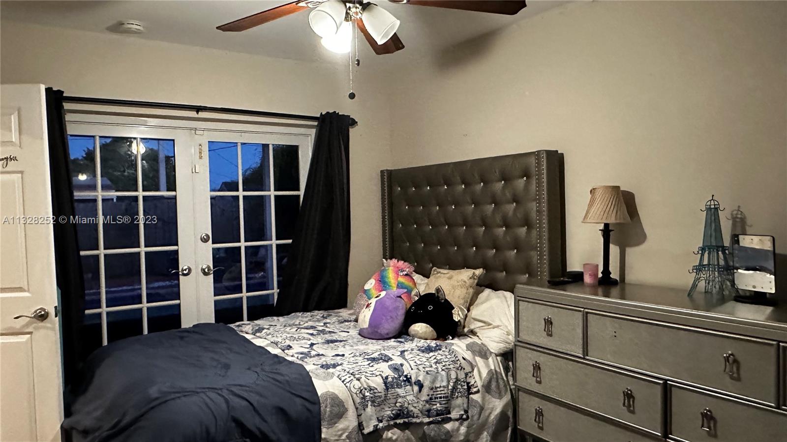7810 Raleigh Street Hollywood, FL 33024 - Photo 14 of 16 a bedroom with a bed and a chandelier