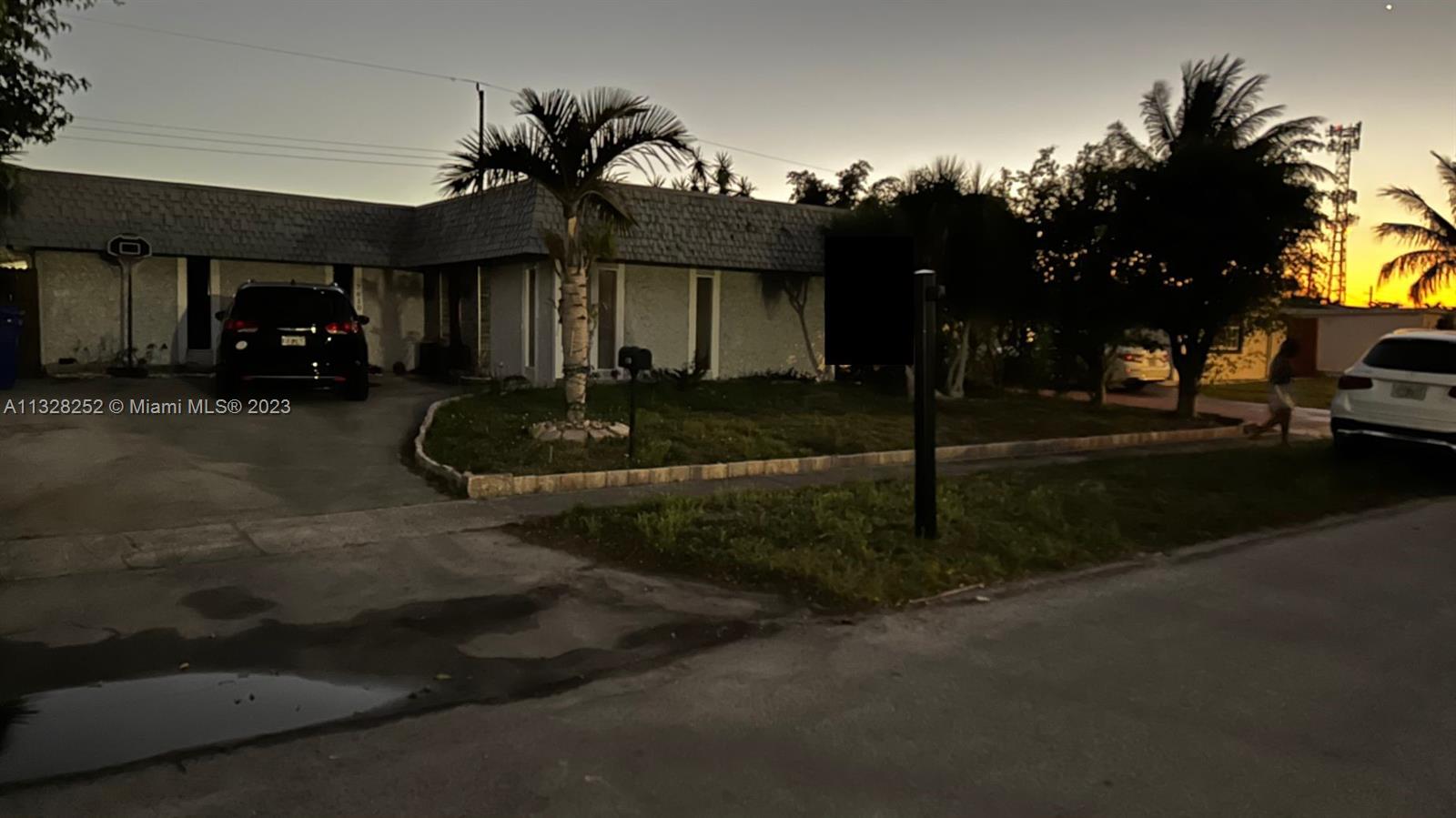 7810 Raleigh Street Hollywood, FL 33024 - Photo 4 of 16 a front view of a house with garden
