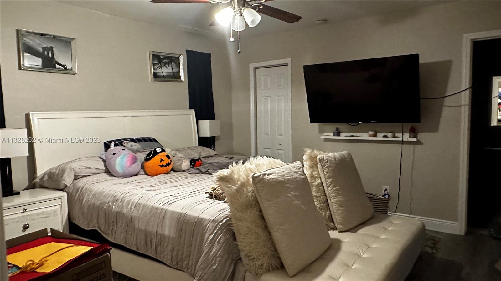 7810 Raleigh Street Hollywood, FL 33024 - Photo 10 of 16 a bedroom with bed and a flat tv screen on dresser