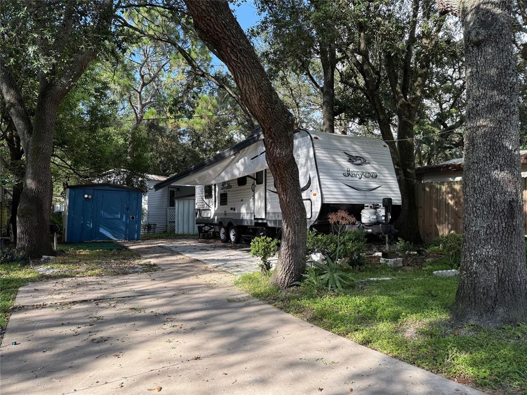 3000 Clarcona Road, Unit 505 Apopka, FL 32703 - Photo 1 of 10 a tree in front of a white house