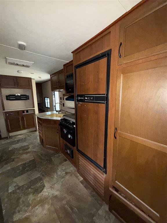 3000 Clarcona Road, Unit 505 Apopka, FL 32703 - Photo 3 of 10 a kitchen with refrigerator and cabinets