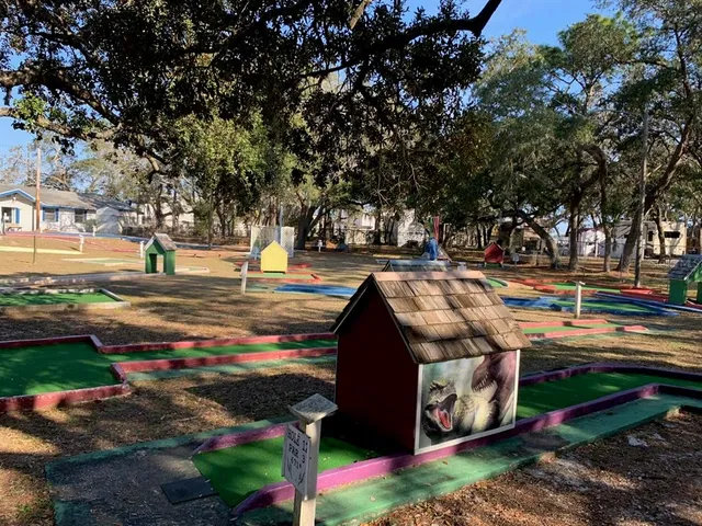 a view of swimming pool with seating area and trees in the background
