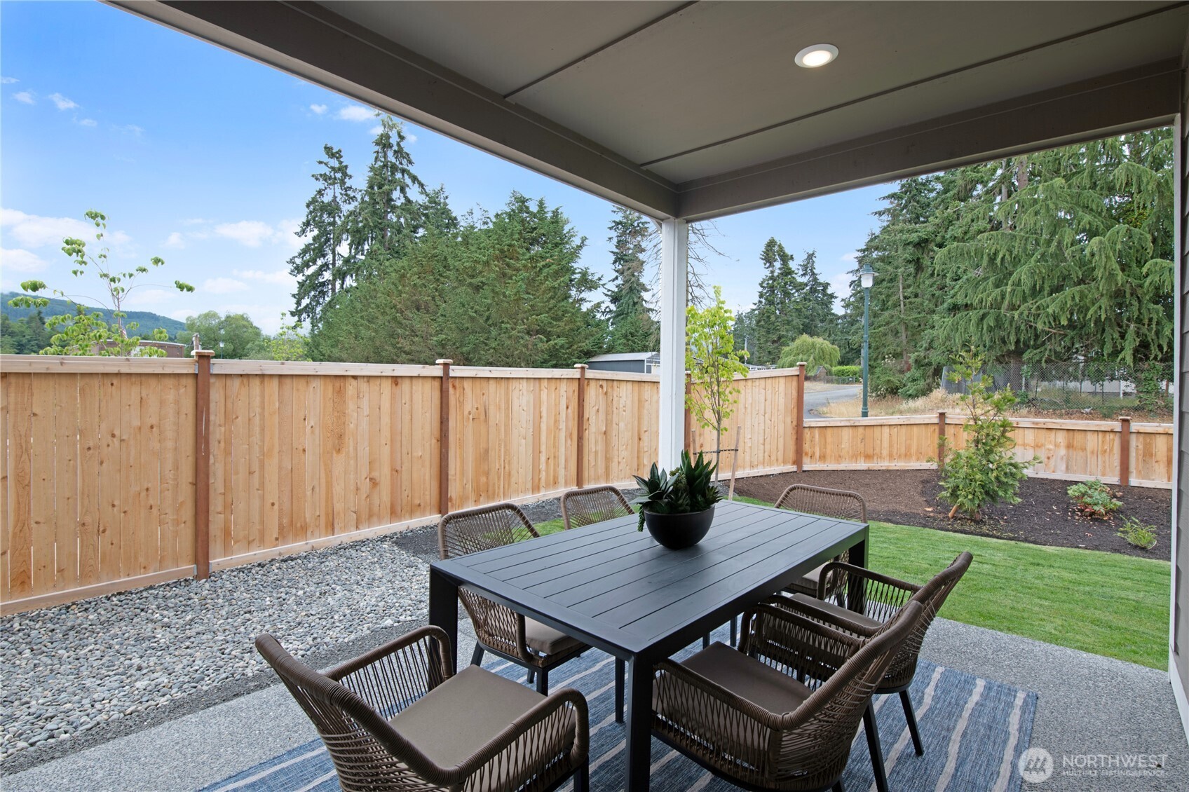 592 Sunbeam Place Sequim, WA 98382 - Photo 12 of 23 a view of an outdoor dining space with a table and chairs