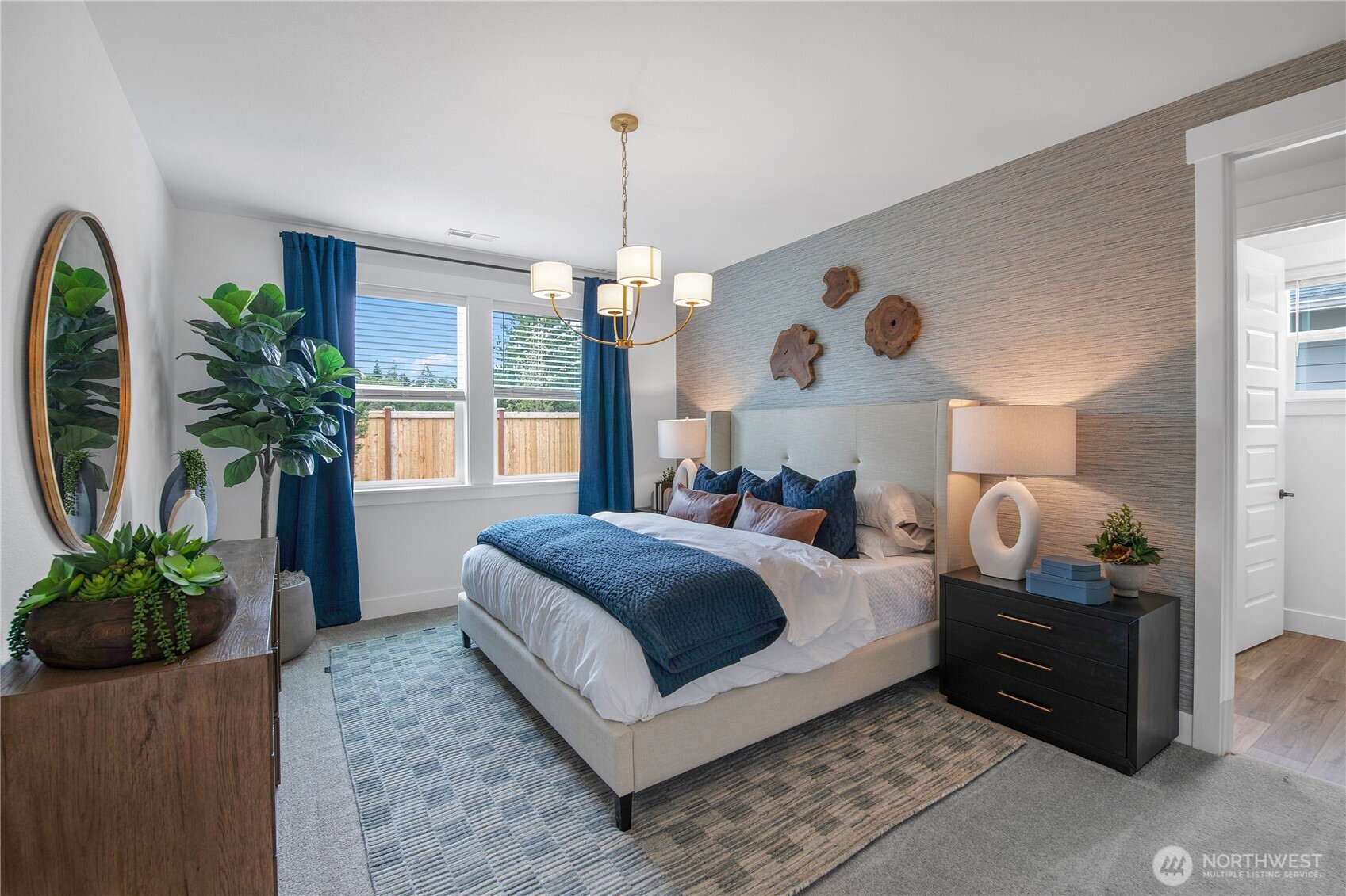 592 Sunbeam Place Sequim, WA 98382 - Photo 14 of 23 a bedroom with bed and a chandelier