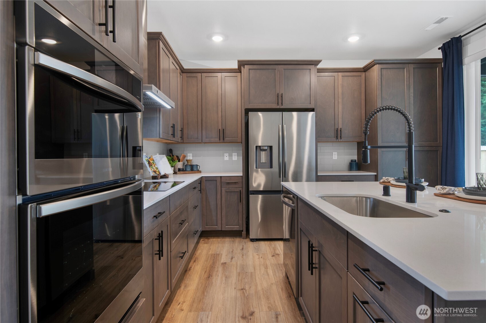 592 Sunbeam Place Sequim, WA 98382 - Photo 3 of 23 a kitchen with a refrigerator sink and cabinets