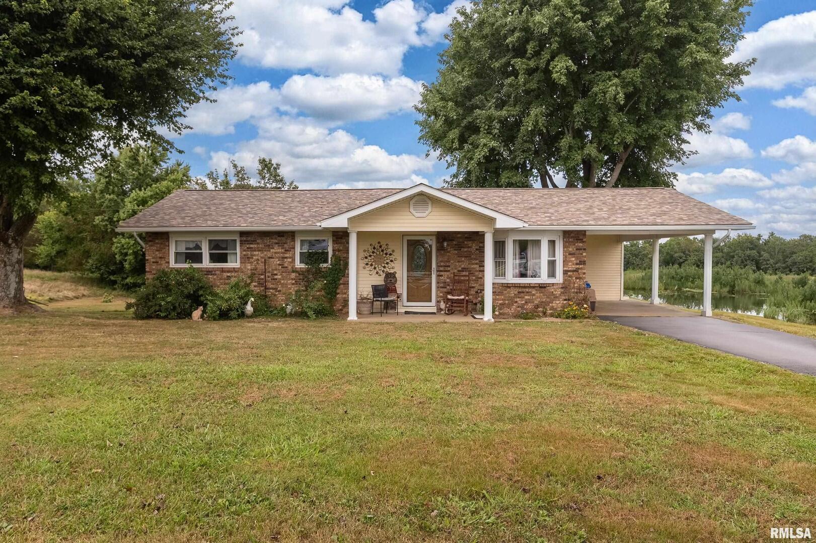 16768 Boundary Road Creal Springs, IL 62922 - Photo 1 of 21 a front view of a house with a garden
