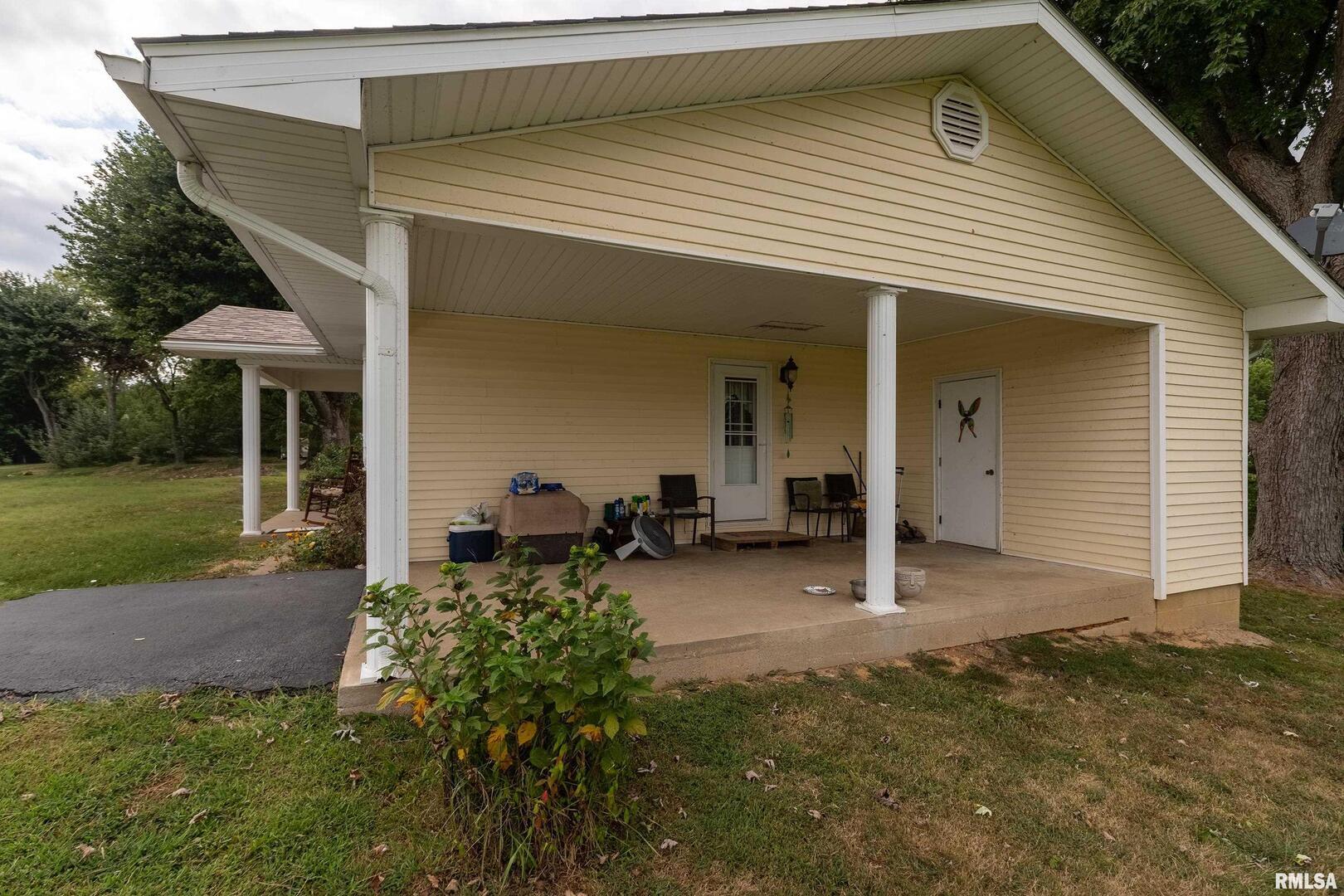 16768 Boundary Road Creal Springs, IL 62922 - Photo 16 of 21 a backyard of a house with seating space