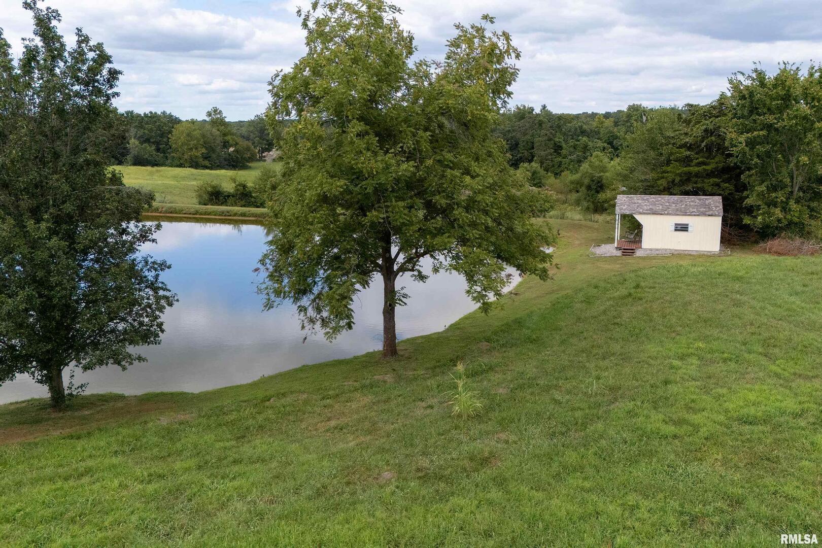 16768 Boundary Road Creal Springs, IL 62922 - Photo 20 of 21 a view of a back yard of a house with a lake view