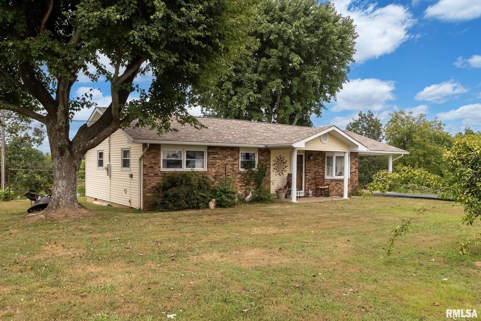 16768 Boundary Road Creal Springs, IL 62922 - Photo 2 of 21 a front view of a house with a garden