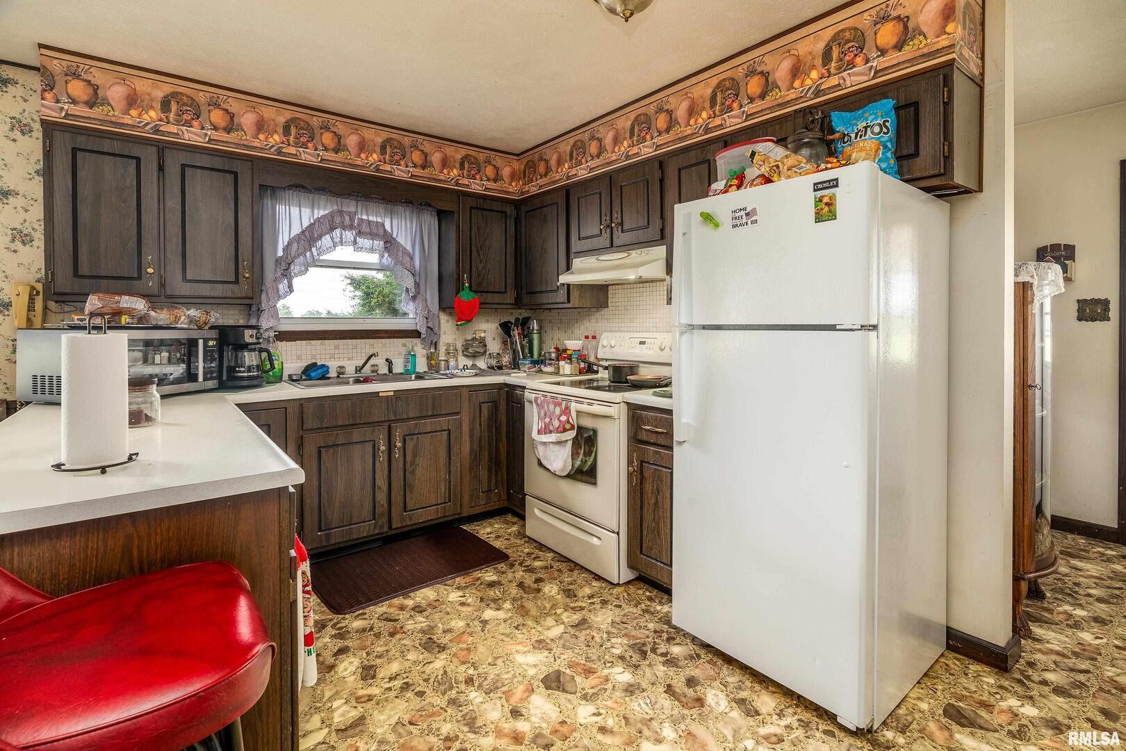 16768 Boundary Road Creal Springs, IL 62922 - Photo 6 of 21 a kitchen with a sink a refrigerator and a stove