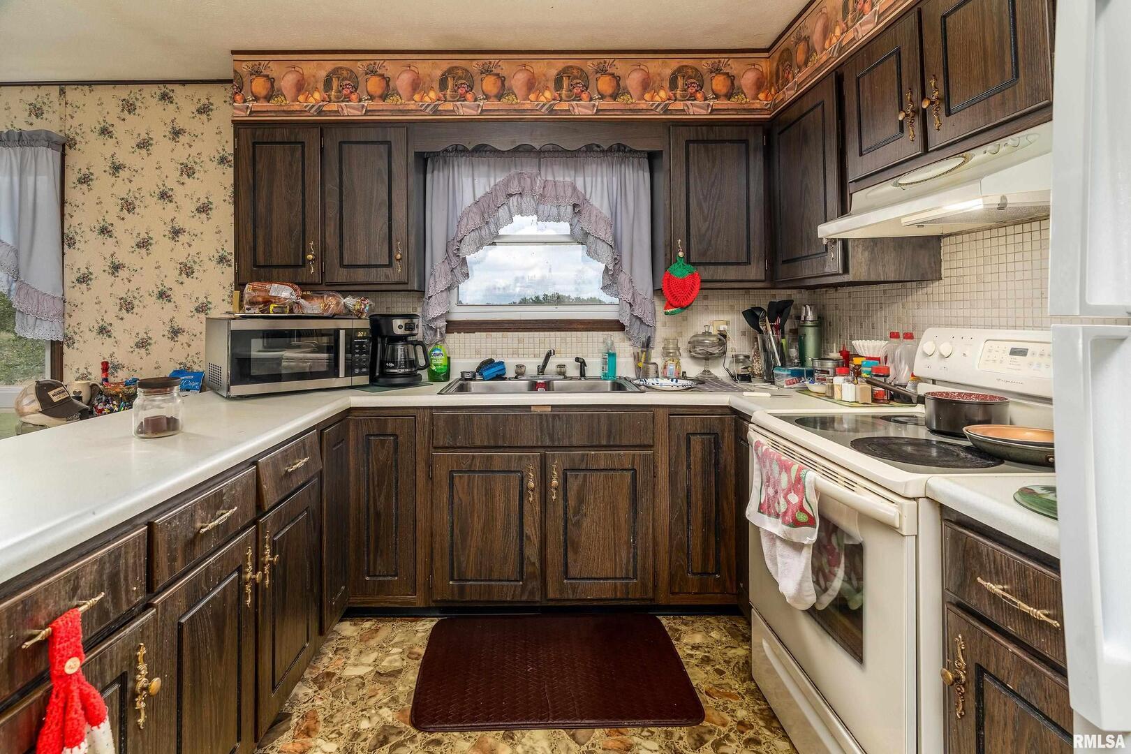 16768 Boundary Road Creal Springs, IL 62922 - Photo 7 of 21 a kitchen with a sink stove and cabinets