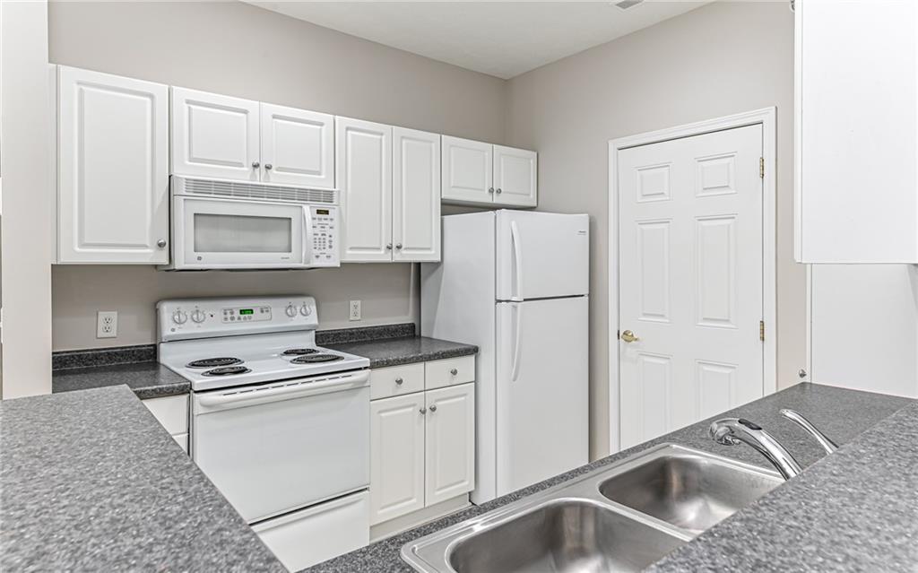1012 Stockton Ridge Cranberry Township, PA 16066 - Photo 13 of 32 a kitchen with white cabinets and white appliances