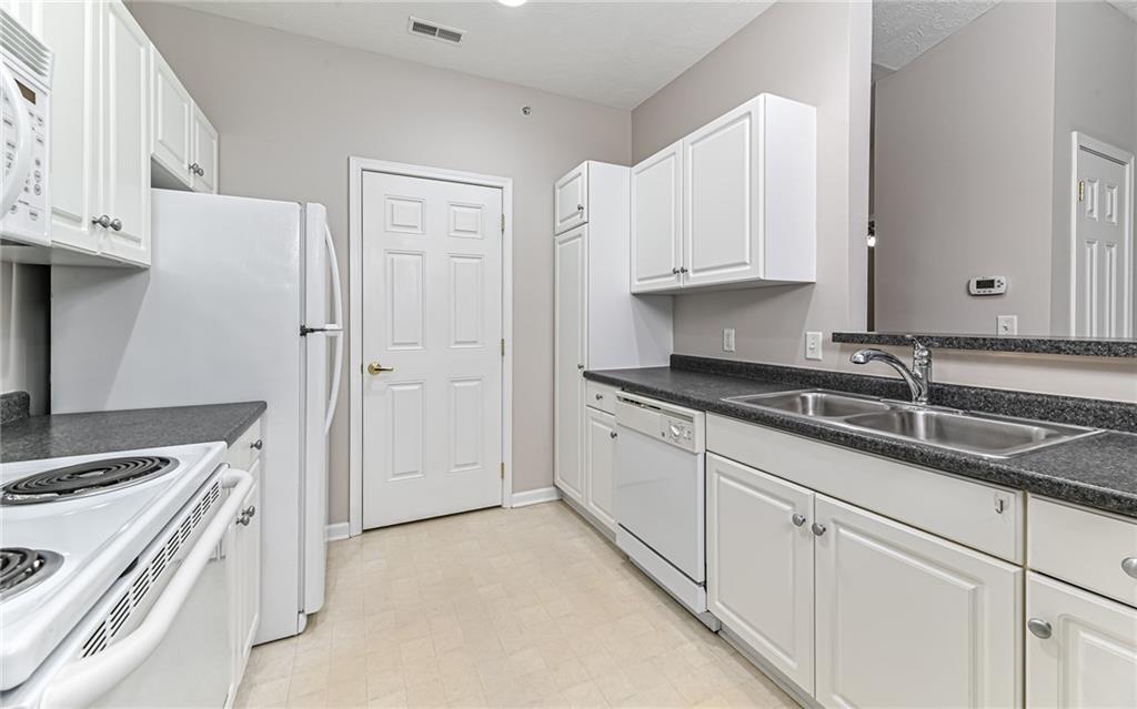 1012 Stockton Ridge Cranberry Township, PA 16066 - Photo 14 of 32 a kitchen with granite countertop a sink stove and refrigerator