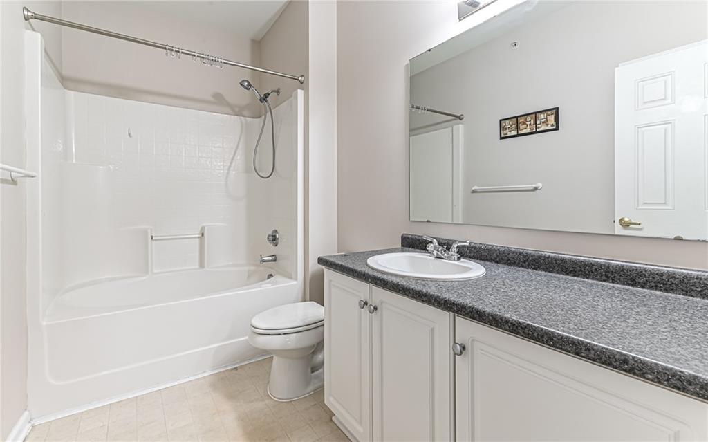 1012 Stockton Ridge Cranberry Township, PA 16066 - Photo 20 of 32 a bathroom with a granite countertop sink a toilet and a large mirror
